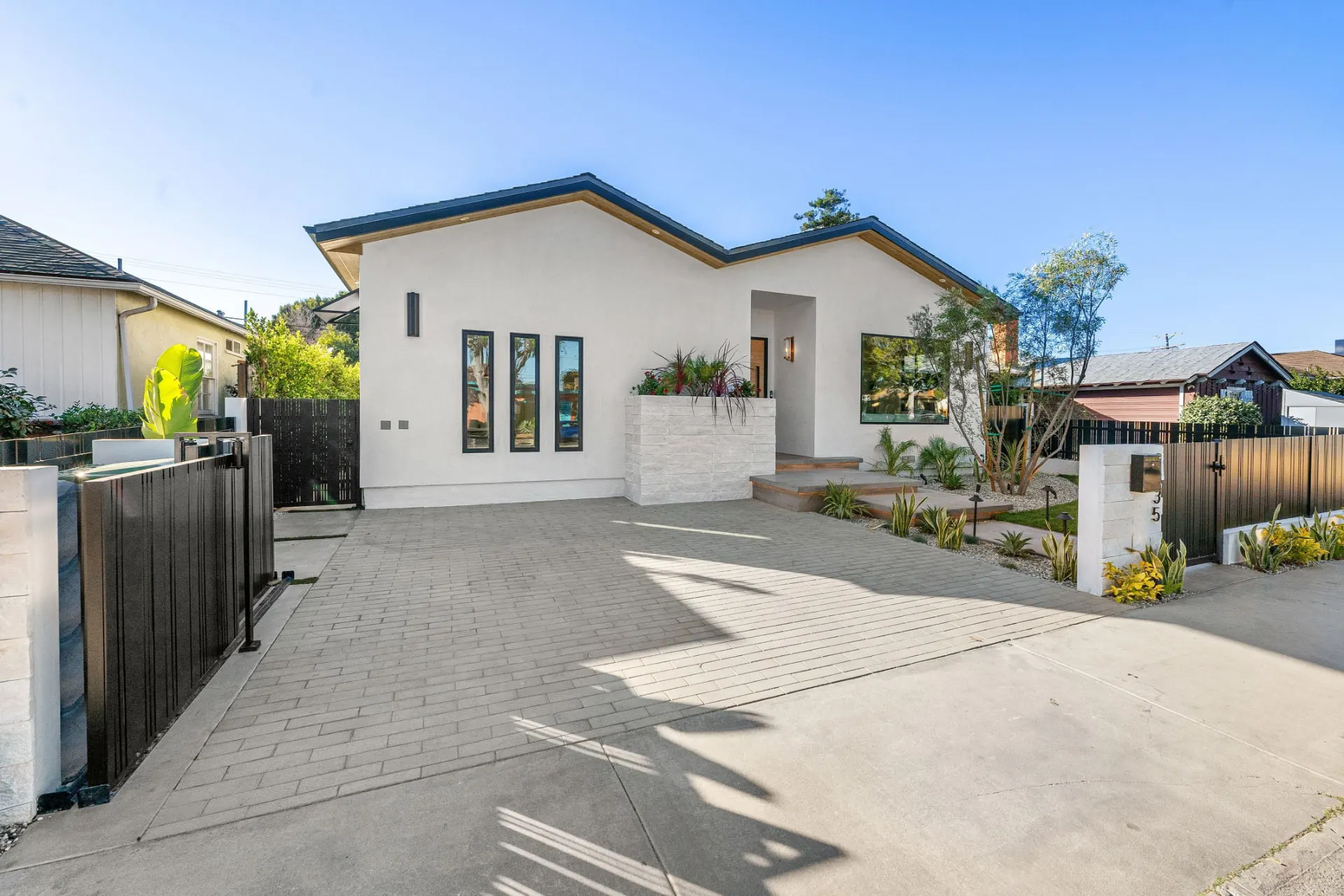 Block-paved driveway in front of a rendered house