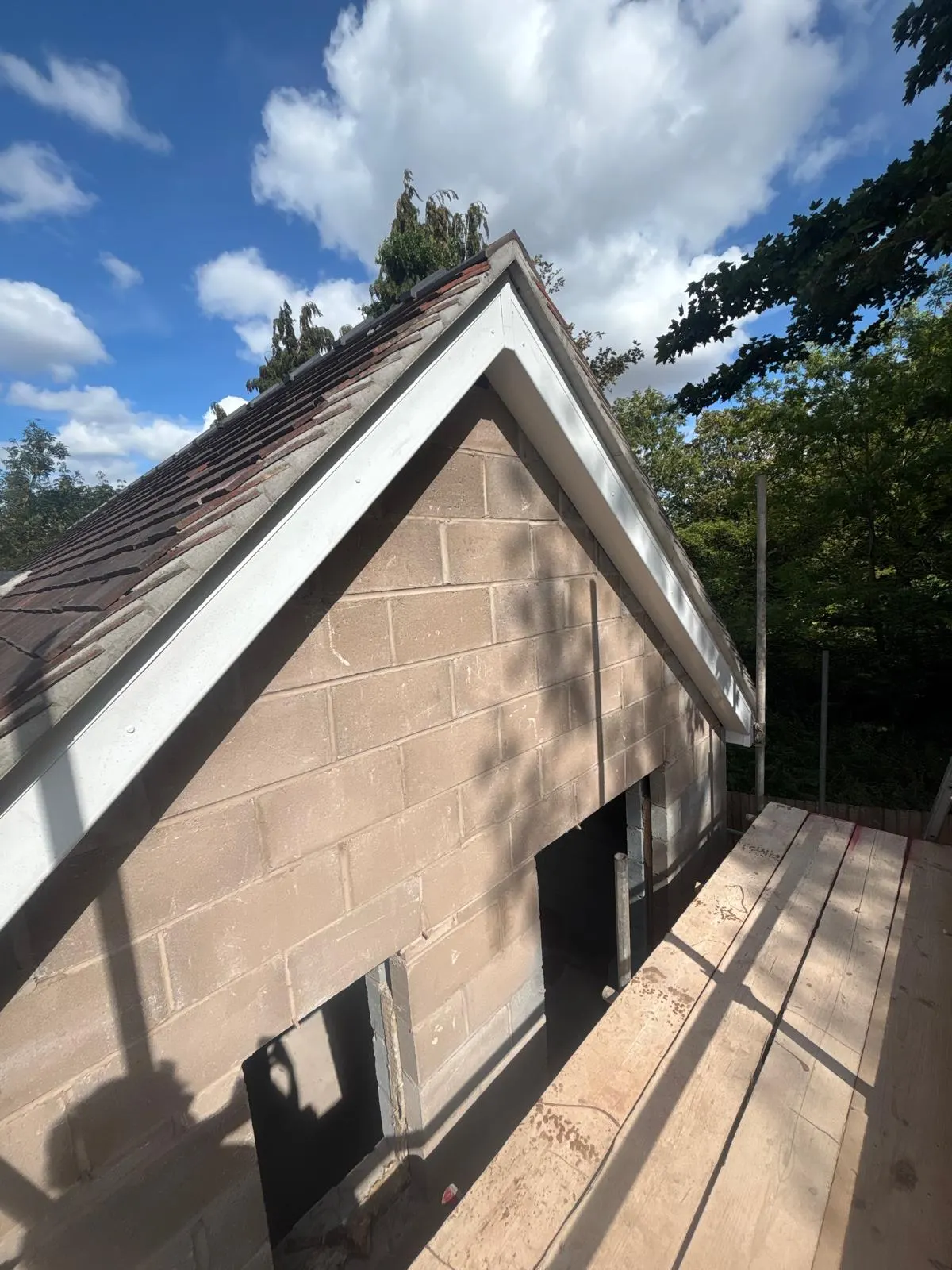 Finished rendered gable viewed from scaffold alongside the roof